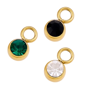 Three round cut gemstone pendants in green, black, and clear with gold-plated metal frames
