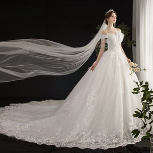 Luxurious off-shoulder wedding dress with sequined lace embroidery and a long bridal veil