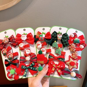 Handmade Christmas hair clip set featuring festive bows, snowmen, and Santa Claus on white card
