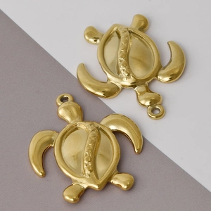 Detailed view of two polished gold stainless steel turtle pendants for DIY jewelry making