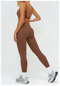 Detail view of coffee brown yoga set with hollow-out back sports bra and high-waist leggings
