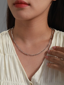 Close-up of minimalist silver chain necklace with alternating oval links on model