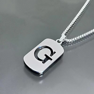 Detailed view of silver titanium steel G-letter pendant necklace on box chain