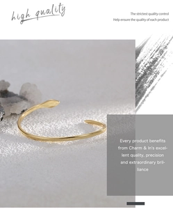 Primer plano macro de pulsera dorada ajustable con forma de serpiente sobre piedra rugosa