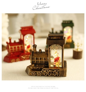 Close-up of vintage bronze Santa lantern with glowing LED lights and swirling glitter