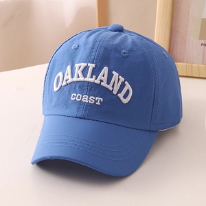 Detailed view of the royal blue quick-dry baseball cap with white OAKLAND embroidery