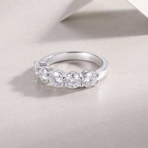 Detail of five sparkling round-cut stones set in a polished silver band ring