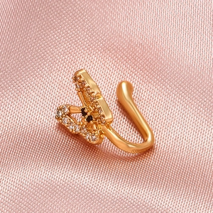 U-shaped gold butterfly fake nose ring with black and white rhinestones on pink silk