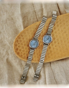Detailed macro shot of vintage silver ladies quartz watches with light blue dials