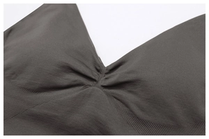 Detail of seamless yoga bra with ruched center and ribbed texture in charcoal grey