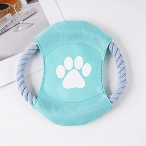Detail of durable teal and blue cotton rope dog frisbee with a white paw print design