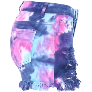 Detail of pink and blue tie-dye denim shorts featuring side ripped holes and frayed hems