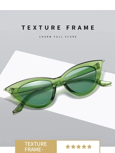 Detailed macro view of green cat eye sunglasses with metal rivets and texture frames