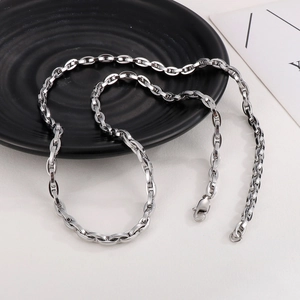 Detail of silver stainless steel coffee bean link chain necklace with lobster clasp