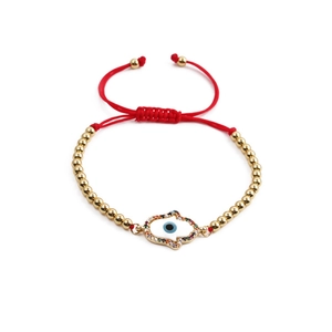 Bracciale etnico con Mano di Fatima e Malocchio, perline dorate e cordino rosso