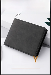 Detail of minimalist black bifold wallet showing neat stitching on matte leather texture