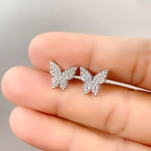 Close-up of sparkling cubic zirconia micro-pave butterfly stud earrings in silver