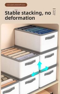Close-up of stackable white fabric wardrobe organizers with grey reinforced handles