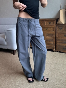 Detailed macro view of grey wide-leg lounge pants with natural micro-wrinkle texture