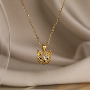 Vue macro du collier avec pendentif chien doré orné de cristaux sur fond en soie
