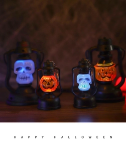 Detail of Halloween LED lanterns with glowing skull and pumpkin designs on wood