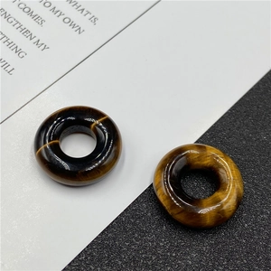 Macro detail of natural tiger eye stone bead with polished brown cat-eye texture