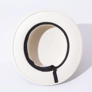 Internal detail of white wool felt hat showing 100% wool label and black sweatband