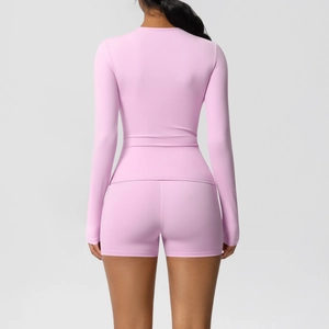 Detail of pink long sleeve yoga top and high waist shorts with seamless back view