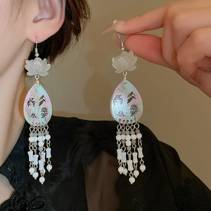 Detail of Chinese style earrings with lotus petals, teardrop pendant and bead tassels