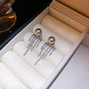 Detailed close-up of grey pearl earrings with sparkling silver rhinestone fringe tassels
