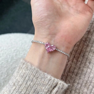 Close-up of S925 sterling silver bracelet with pink heart stones and pavé cubic zirconia