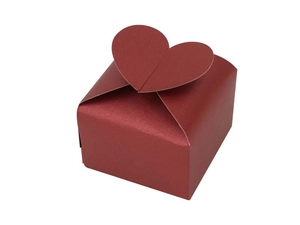 Detailed view of a red pearlescent paper candy box with a unique heart-shaped closure