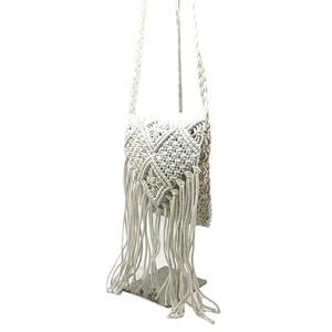 White boho macramé shoulder bag with fringe tassel and hand-woven geometric textures