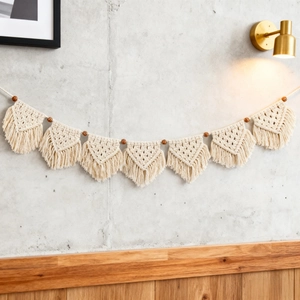 Handmade beige macrame wall hanging with cotton fringe and wood beads in boho style