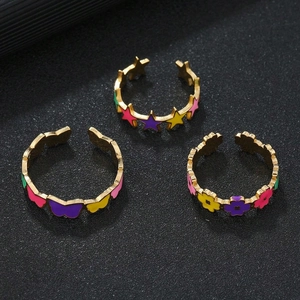 Colorful enamel star, butterfly and flower stainless steel open rings on black background