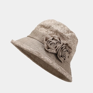 Detail of coffee floral sun hat for elderly women with cloth rose decoration