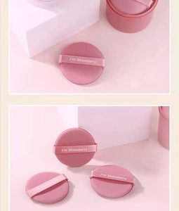Close-up of pink non-latex powder puffs with strawberry text and satin ribbon detail
