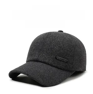 Close-up of winter baseball cap for men with warm ear flaps and sport metal ornament