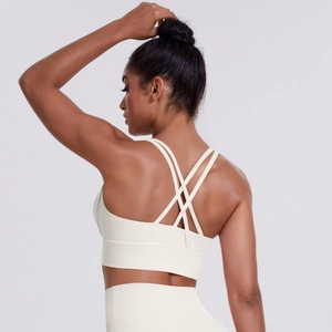 Detail of cross-back thin straps and ivory white breathable fabric on sports bra