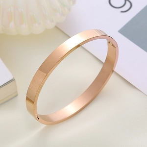 Minimalist rose gold stainless steel bangle with polished finish and hidden buckle
