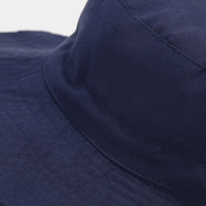 Detail view of reinforced double-stitching on navy blue cotton sun hat with durable texture