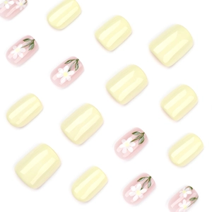Short square press-on nails with yellow finish and white daisy floral nail art designs