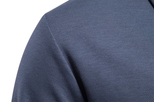 Macro shot of breathable pique knit fabric and seamless shoulder stitching on a polo shirt