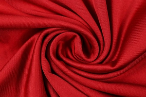 Detailed macro view of vibrant red knit fabric showing premium texture and weave