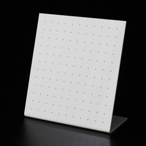 Detailed view of white L-shaped acrylic jewelry stand with multi-hole design for earrings