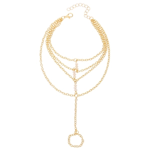 Multi-layer gold chain slave bracelet with white beads and integrated finger ring