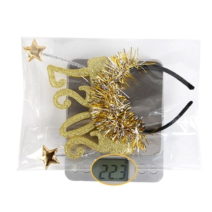 Close-up of golden glitter 2023 New Year headband with stars weighing 22.3 grams