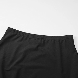 Close-up of reinforced double-stitched waistband on black elastic fabric skirt