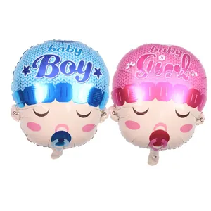 Close-up of baby boy and girl face foil balloons with baby shower lettering detail