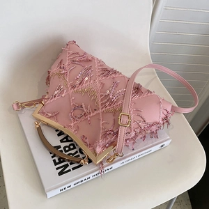 Detail of pink vintage handbag featuring exquisite embroidery, sequins, and resin handle